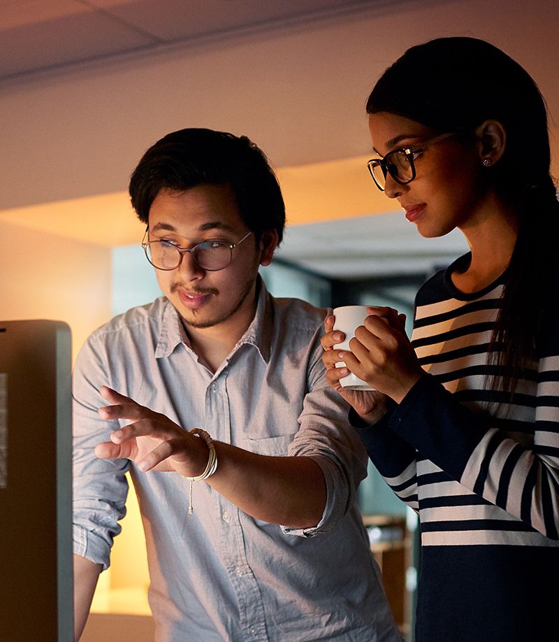 two-engineers-with-digital-code-overlay-getty-1183941922