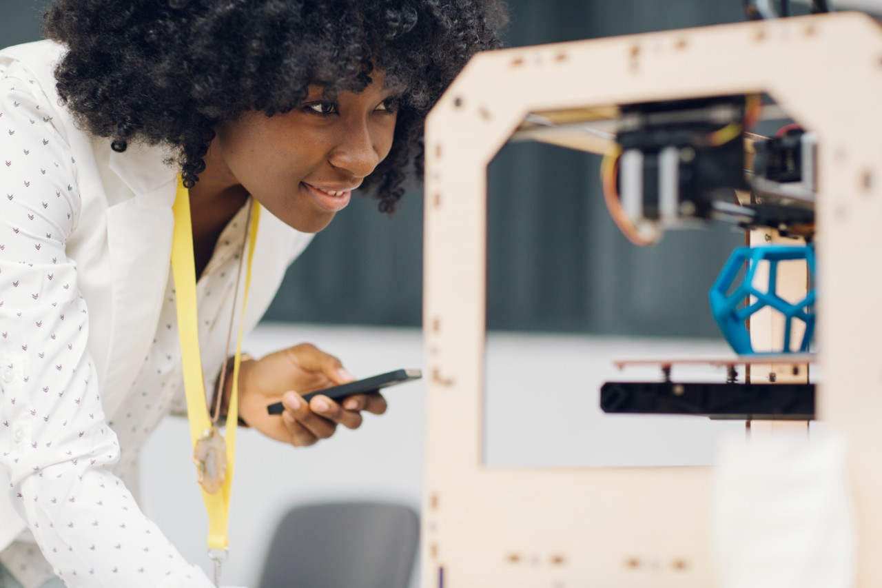 Female engineer working on 3D printer additive manufacturing
