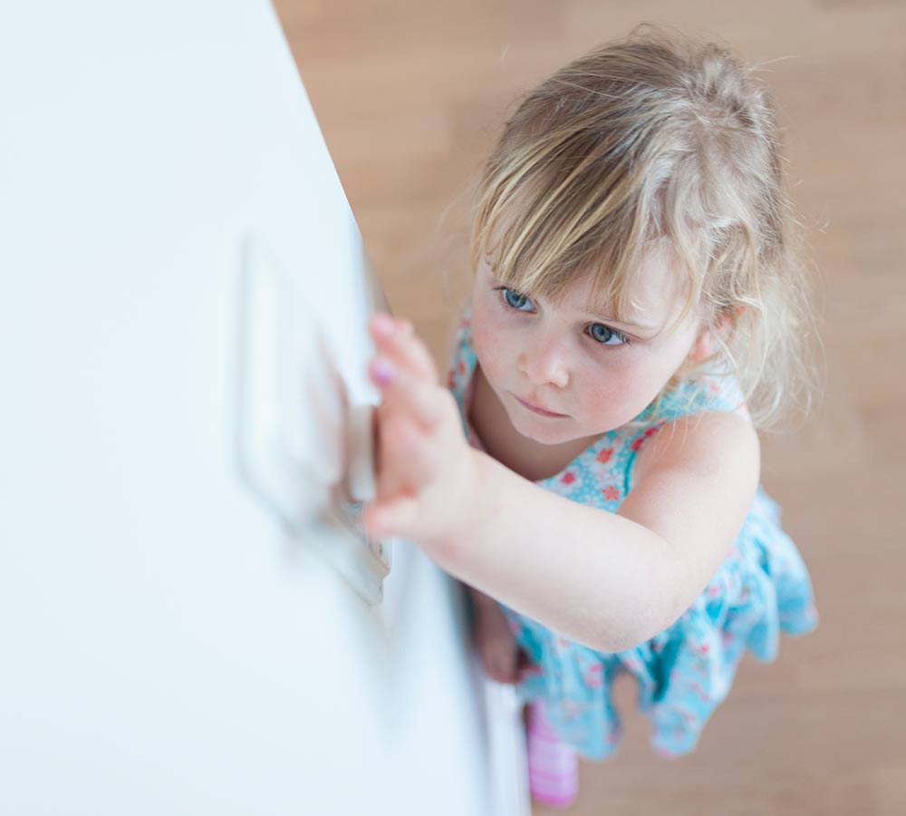 little-girl-reaching-up-to-light-switch-dimmer.jpg