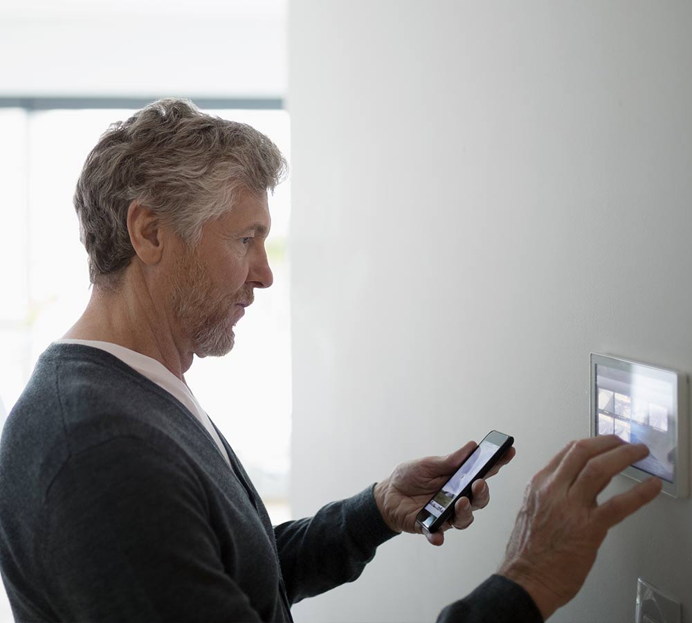 gentleman-with-smartphone-smart-thermostat.jpg