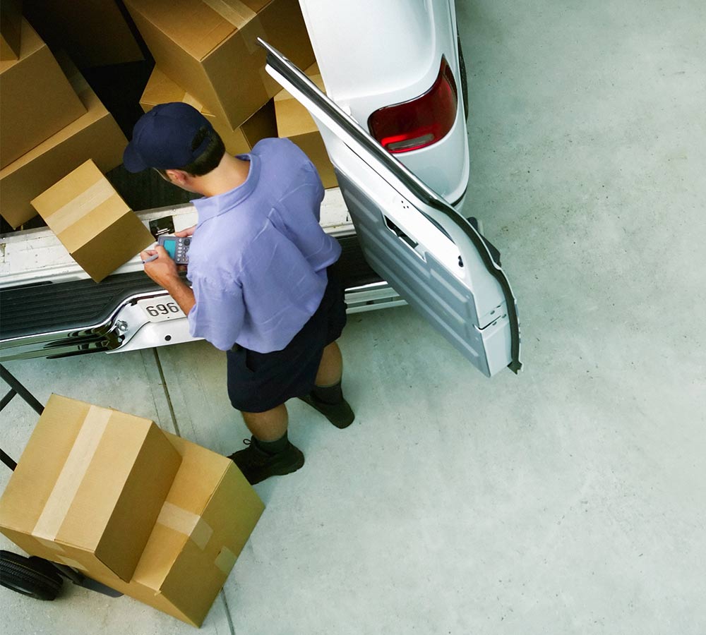 delivery-man-scanning-packages-near-truck.jpg