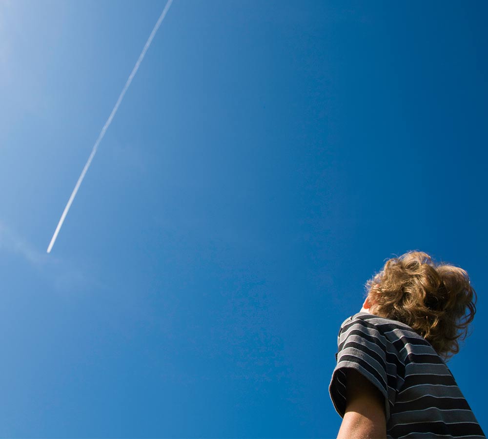 young-boy-looking-up-at-jet-stream.jpg