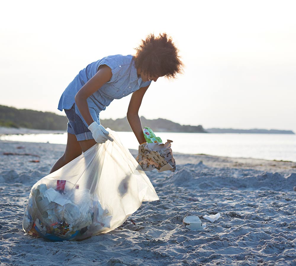 woman-collecting-trash-on-the-beach.jpg