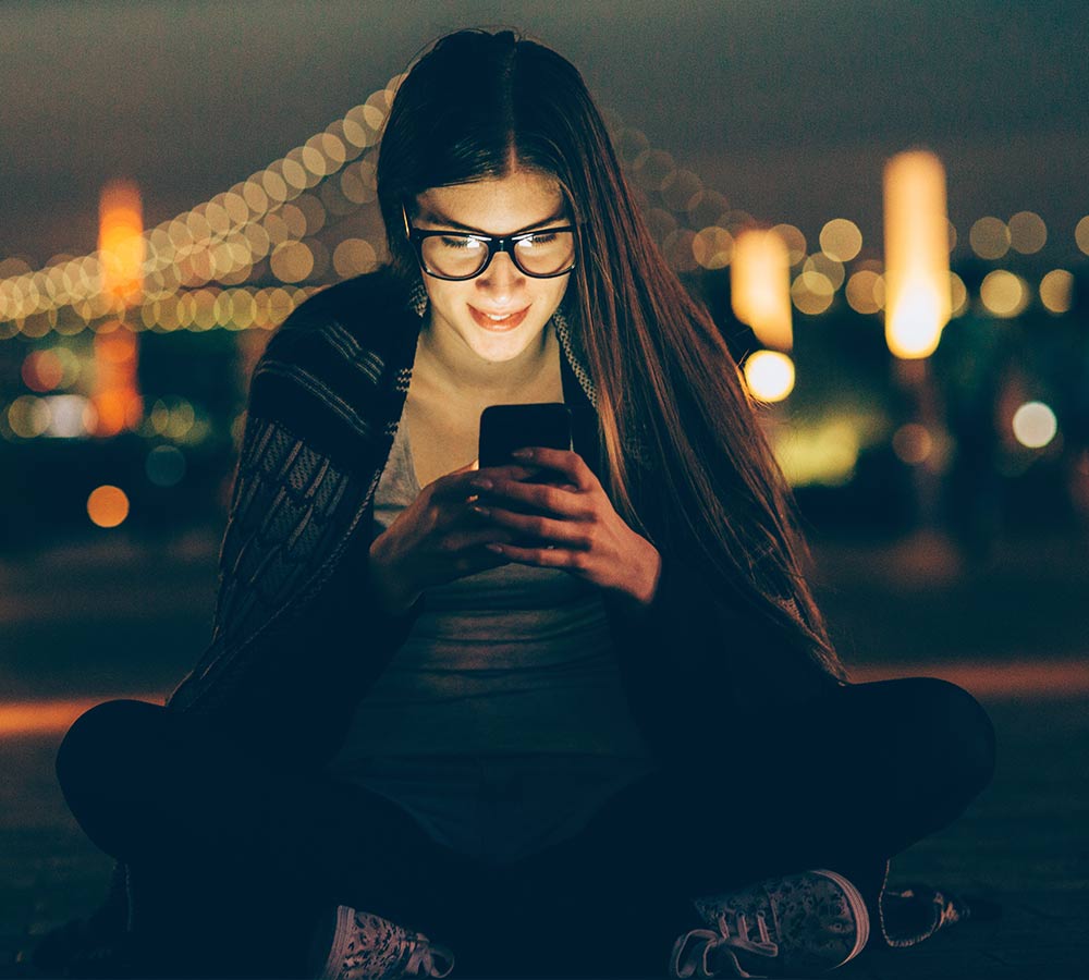 girl-with-glasses-looking-at-smartphone.jpg