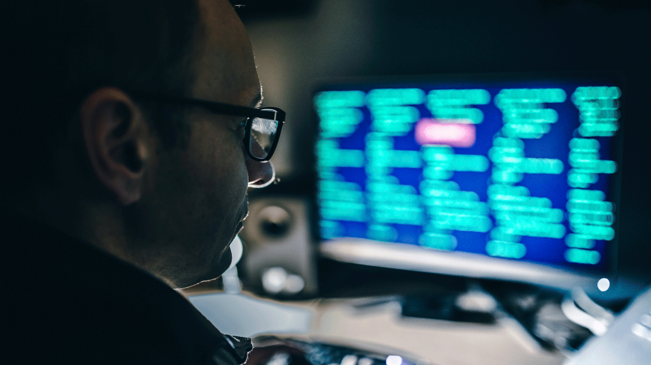 hacker sitting in front of a computer