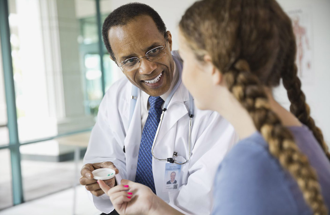 Doctor giving pills