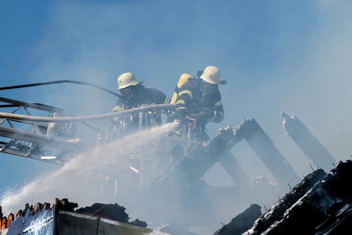 fire fighters in fire-fighting operation trying to put out electrical ignited fire