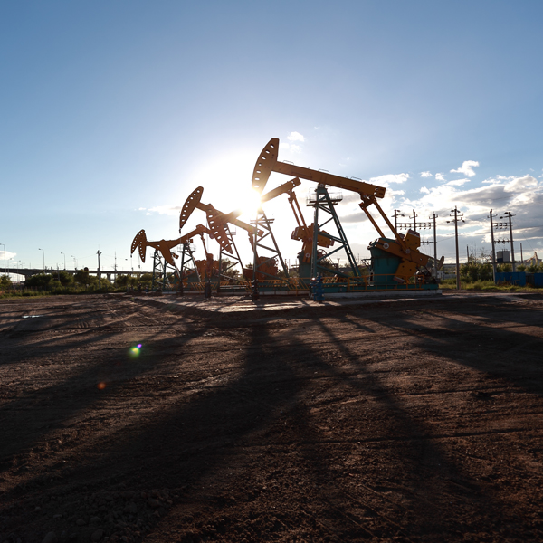Line of oil rigs in a field
