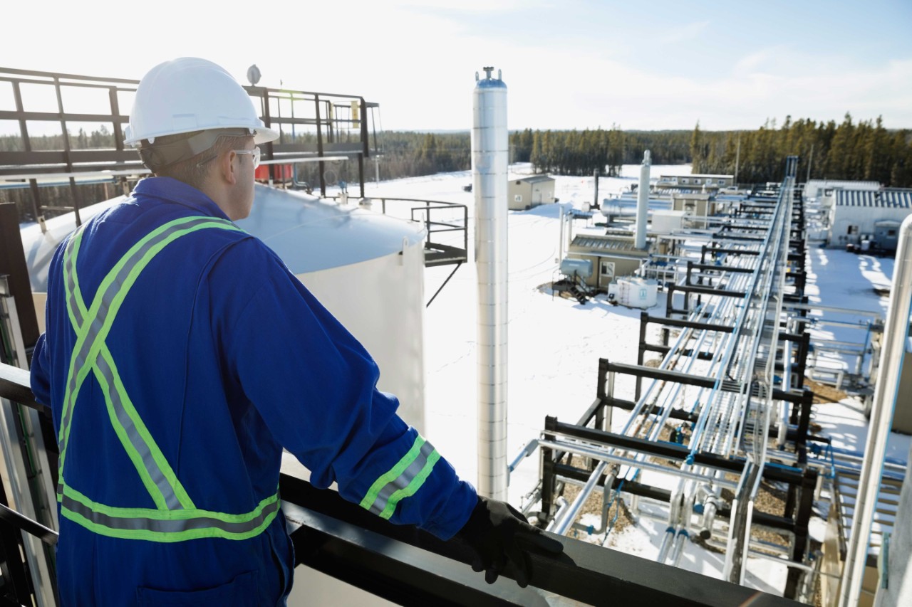 Man overseeing an oil and gas operation