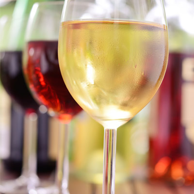 A variety of wines displayed in glasses with depth of focus.