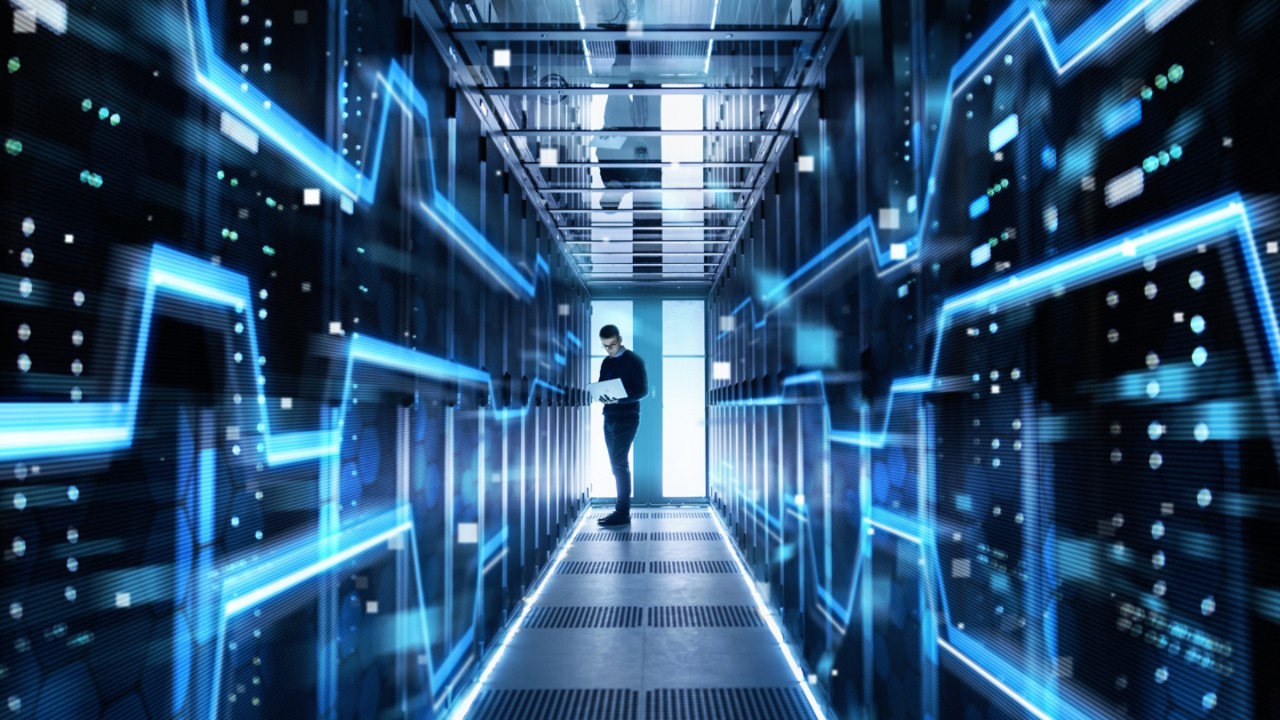 diminishing-perspective-of-man-working-in-server-room-getty-943065400