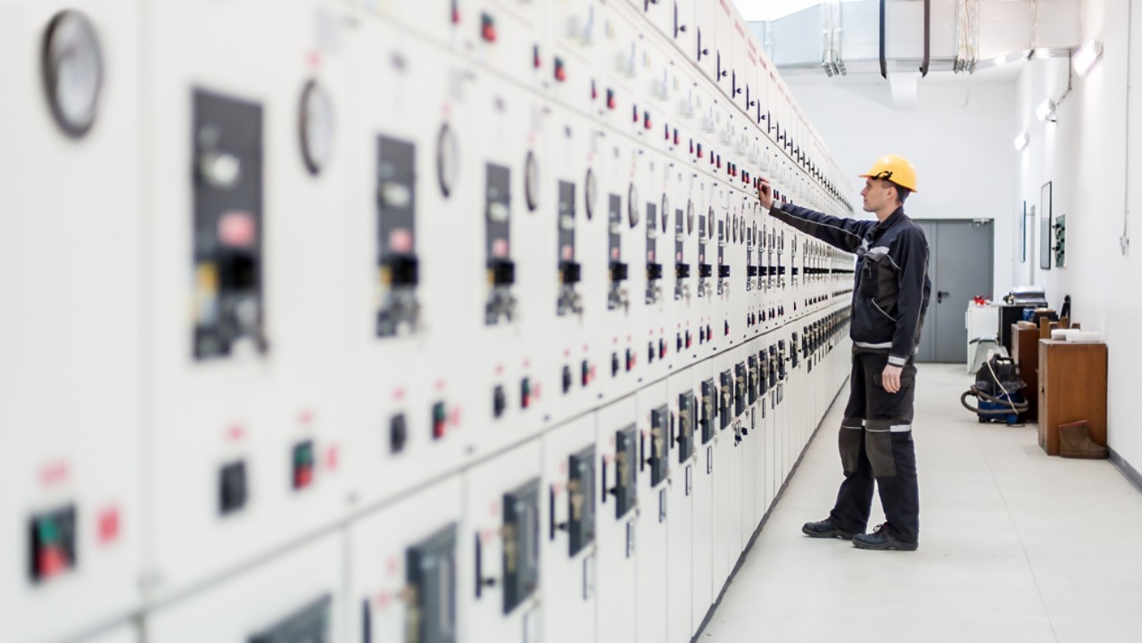 Engineer commissioning bay control unit. Engineering department. Medium voltage switchgear