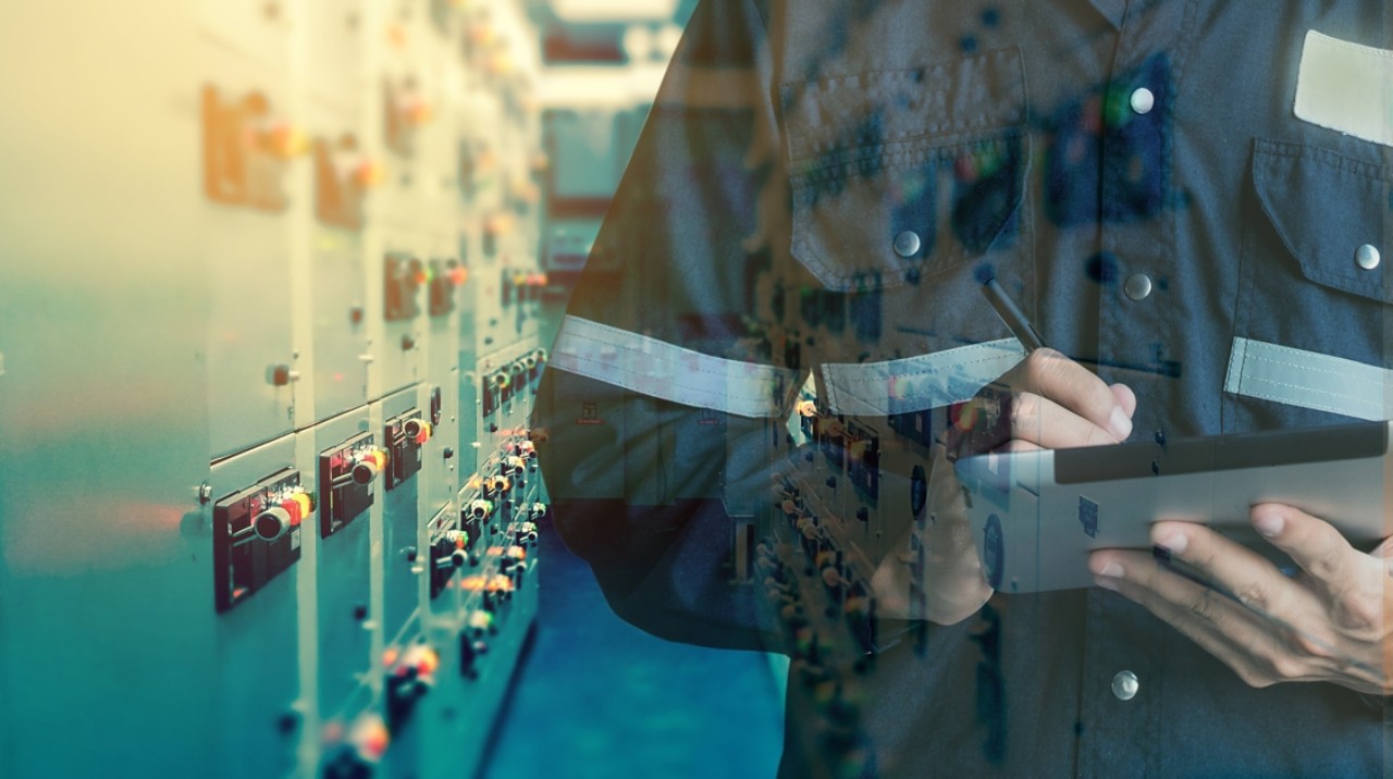 Man on phone pointing at substation
