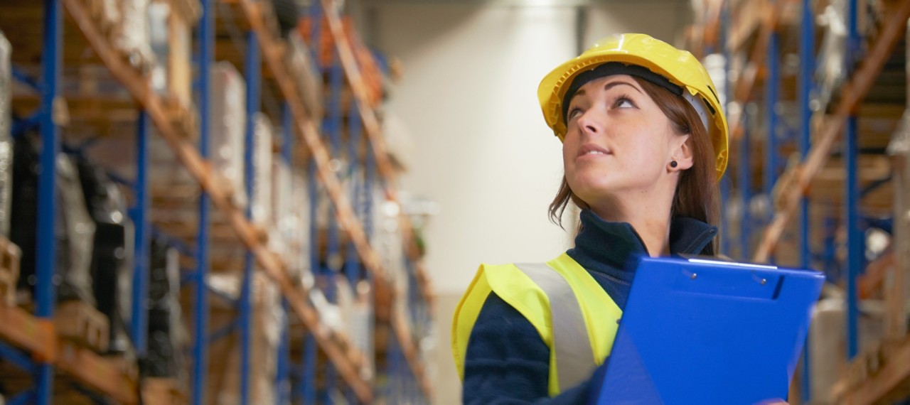 Worker checking stock in warehouse inventory freight transportation 3000X1334