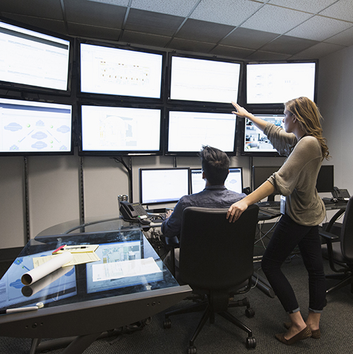 Business people working in control room